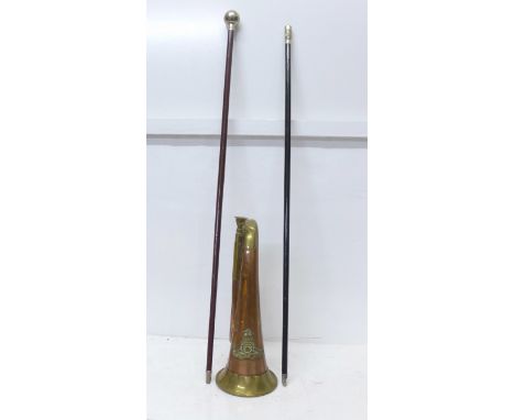 Two swagger sticks and a bugle with Royal Artillery regimental badge 