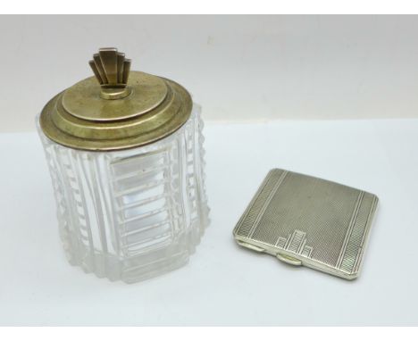 An Art Deco silver compact and a silver topped glass preserve jar, small chips to the rim of the glass 