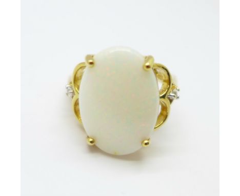 A 9ct gold and opal ring also set with two white stones, 6.4g, N, opal 18mm x 12mm 