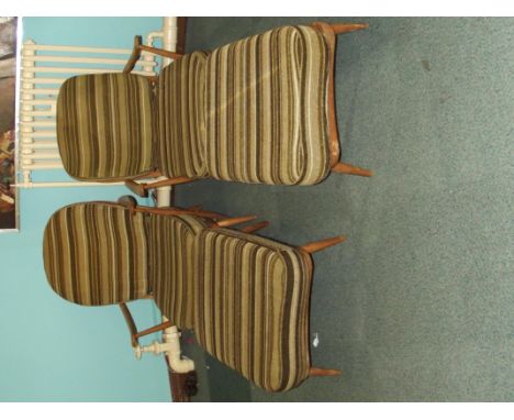 Pair of of stick back Ercol Windsor open armchairs with footstools in beech