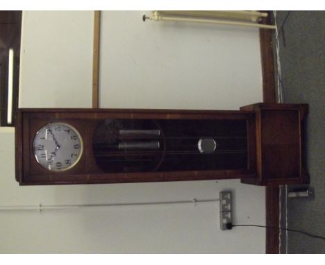 1930's art deco long case clock in oak, circular dial with Arabic numerals, three weight movement, striking on a gong, height