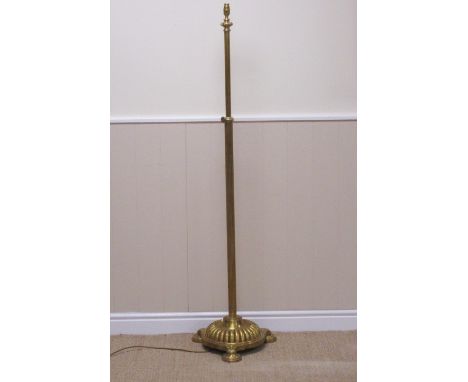 A Regency style brass telescopic Standard Lamp on circular fluted base and three circular feet, 5ft 2in H