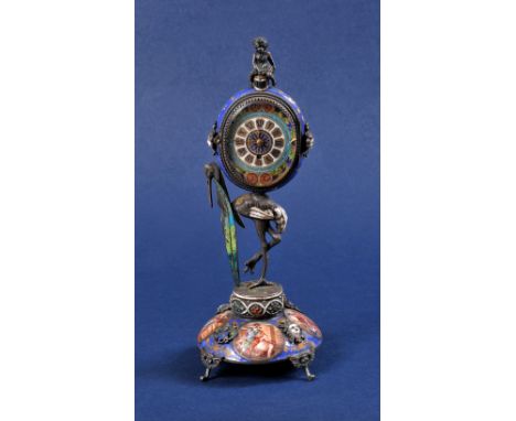 A 19th Century Swiss enamel Timepiece with oval dial having roman numerals, green, blue and red scroll surround, the movement