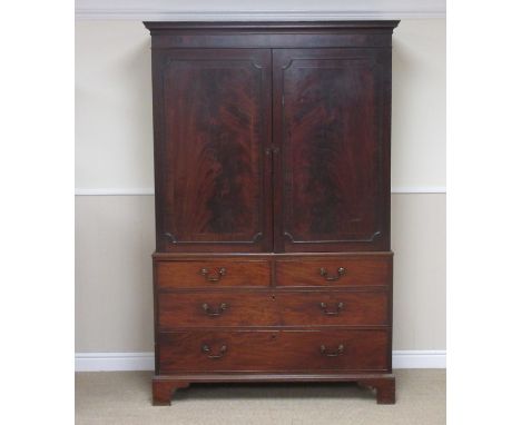 A George III flame mahogany Linen Press, the upper section fitted pair of satinwood strung panel doors above base fitted two 