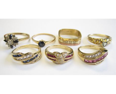 A Diamond and Ruby Ring pavé-set brilliant-cut diamond to cross between two rows of channel-set calibre-cut rubies in 9ct gol