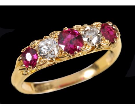 A Ruby and Diamond five stone Ring pavé-set three oval-cut rubies interspersed with old-cut diamonds, stamped 18ct, ring size