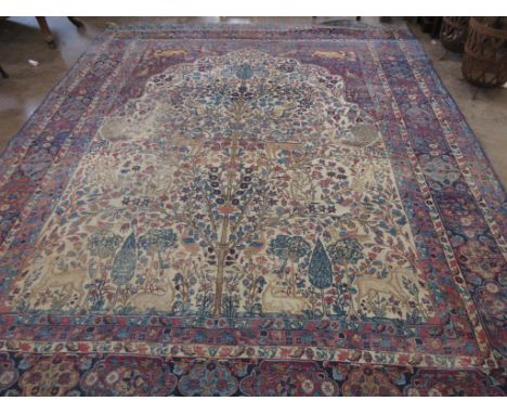 An Oriental woollen Carpet decorated the Tree of Life with birds, deer and flowering plants on cream ground amongst multiple 