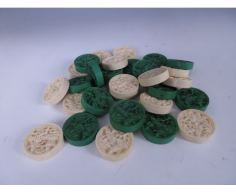 A set of Cantonese carved ivory Backgammon Pieces, green stained and natural