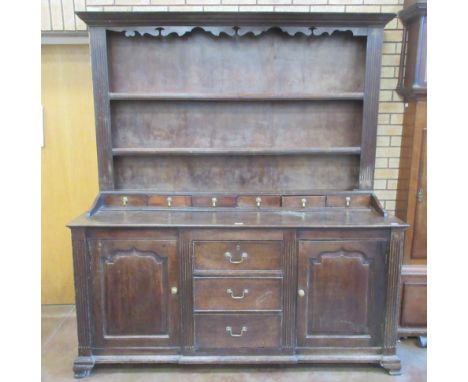 An 18th Century oak enclosed South Wales Dresser and Rack with later backboards, the base fitted six drawers to raised ledge 