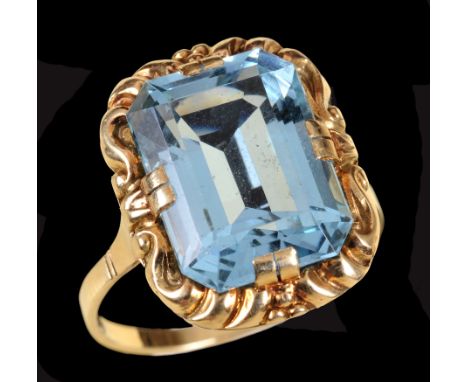 An Aquamarine Ring claw-set step-cut stone, estimated 7cts, in scrolled frame, stamped 585, ring size O