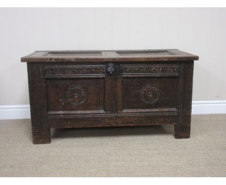 A mid 17th Century oak Coffer of small proportions with pin hinged sunken two panel lid, the front with arrow carved frieze a