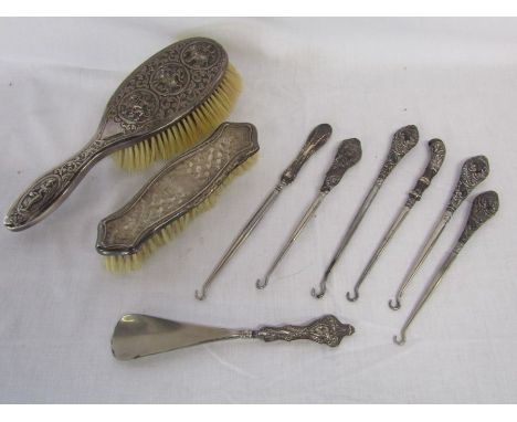 White metal hairbrush with Kali design, silver backed clothes brush, silver handled boot hooks and shoe horn