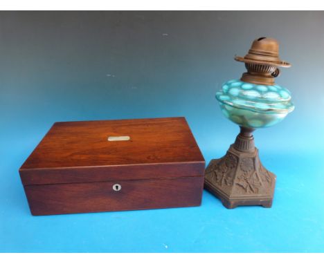 A mother of pearl inlaid writing slope and a cast oil lamp with blue bowl