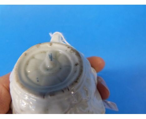 A first period Worcester relief moulded butter boat with hand painted flower decoration (largest diameter 8cm)