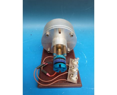 A Tesla steam turbine in fixed case driving direct to a generator and lighting three bulbs