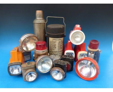 A collection of vintage torches and flasks, includes early Cyde lamps front and rear