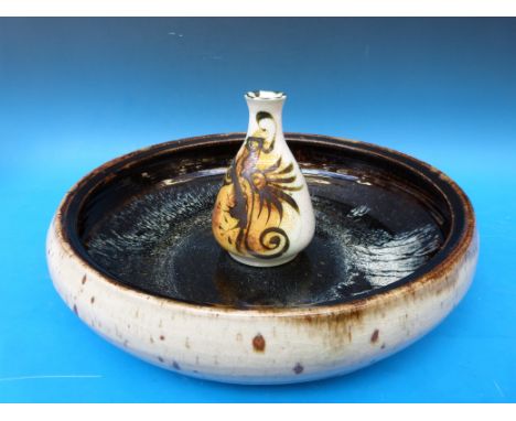 A large circular studio pottery dish, together with a Celtic pottery vase with Newlyn Cornwall label to base (18cm high)