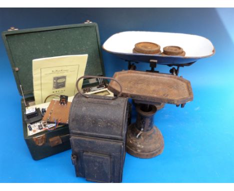 A set of scales marked 'The Acme', a B.R lamp and a radio set with battery kit