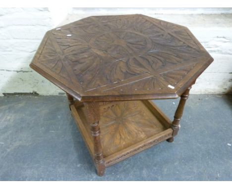 An octagonal carved oak table with shelf below (W91cm) 