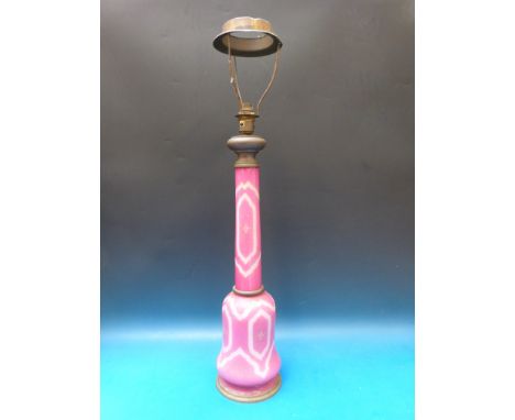 A large pink overlaid cut glass electric lamp decorated with sprays of flowers and brass mounts, 75cm tall. 