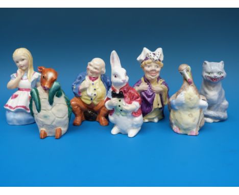 A set of seven Royal Worcester candle snuffers from The Alice in Wonderland Series 