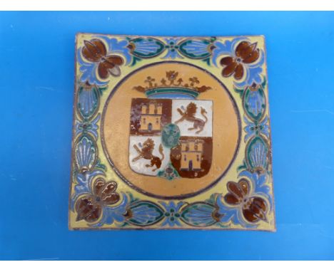 A Iarge Arts and Crafts Armorial tile with foliate border (30cm x 30.5cm)