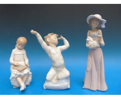 Three Nao figures: a lady with a puppy, a waking boy and a girl with black board (tallest 24cm)