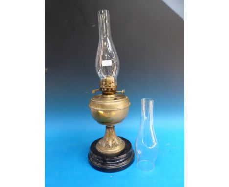 A Duplex brass oil lamp on painted ceramic base 