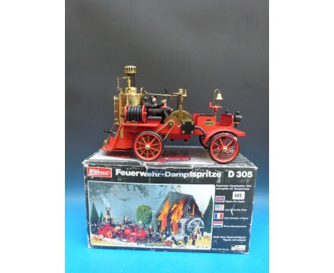 A Wilesco D305 fire engine with free way clutch (rear wheel drive, neutral and water pump), in original box, with four Wilesc