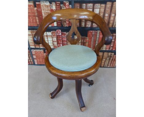 A vintage oak swivel office or captain's chair