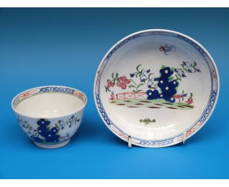 An 18thC teabowl and saucer decorated in enamel possibly Lowestoft