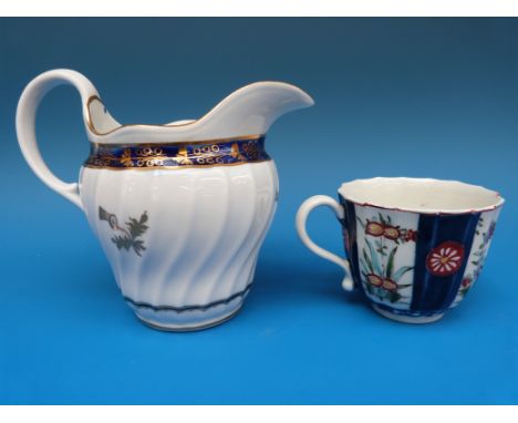 A Worcester wrythen moulded cream jug with thistle motif and an early Worcester teacup (jug 11cm high)