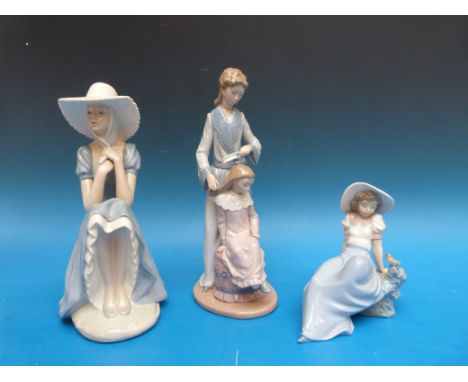 Three Nao figures comprising mother and daughter and two seated girls in bonnets (tallest 29cm)