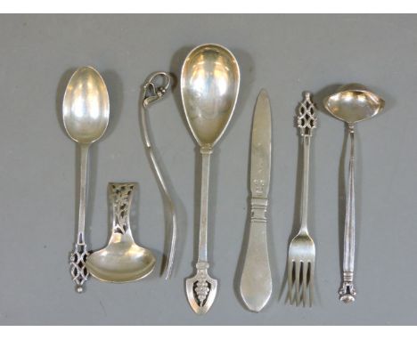 Danish silver, comprising a Georg Jensen toddy ladle, a pickle fork with flower terminal, a letter opener, 15cm long, each fu