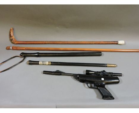 A BSA .22 cal air pistol, an ebonised and brass short sword stick, an African police truncheon, and two walking sticks