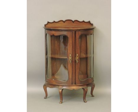 A small bow front display cabinet, a reproduction serpentine serving table, a modern canterbury, and a walnut coffee table