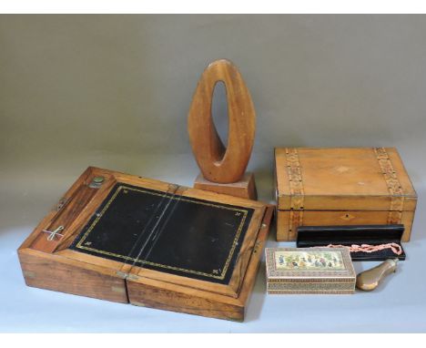 Two 19th century walnut boxes, a powder flask, a sadeli box, and a modern carving