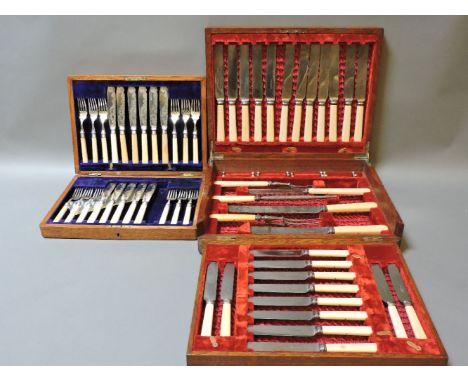 Two oak cased canteens, the first with fish cutlery, the second with carving set, steel knives and stands, a Victorian cast i