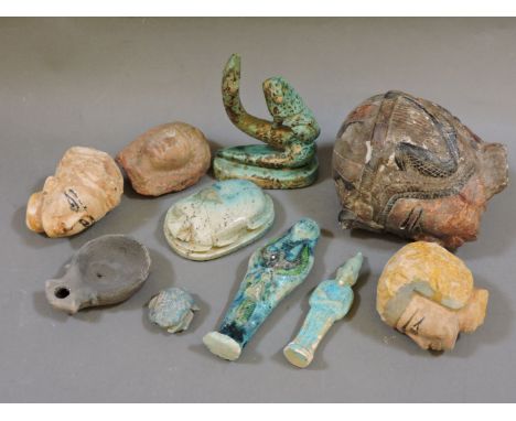 Egyptian artefacts, comprising four heads, lamp, two scarab seals, two ushabti, lion/snake group