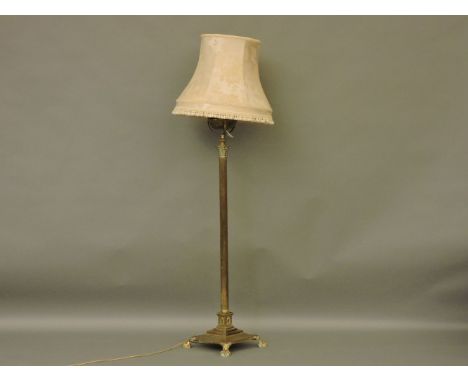 A brass standard oil lamp, converted to electricity, with an adjustable Corinthian column on a square base and paw feet, comp