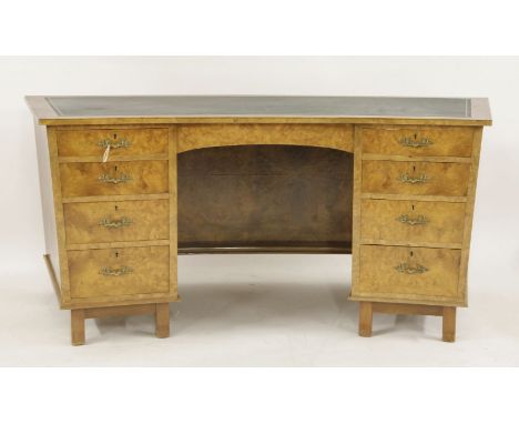 A burr walnut bow front desk, with a green leather top, with four drawers to each side, 176cm wide