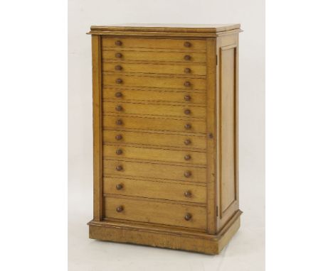 A Victorian oak collector's chest, containing twelve graduated drawers, each with two knop handles, moulded top, panelled sid