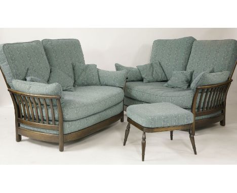 A pair of Ercol two seater settees, and a matching footstool