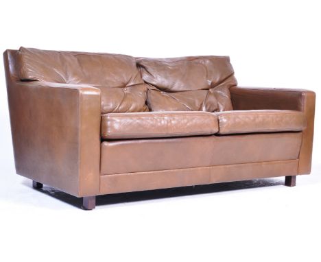 A 20th century Danish retro vintage two seat sofa settee in chocolate brown full grain leather having sweeping side armrests 