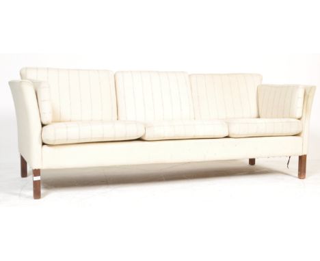 A 1960's retro vintage Danish three seat sofa settee in woollen white upholstery with three striped cushions each to seat and