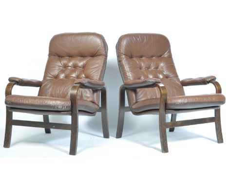 Farstrup - A pair of 20th century Danish stained beech bentwood lounge / sling chairs / armchairs having shaped armrests that