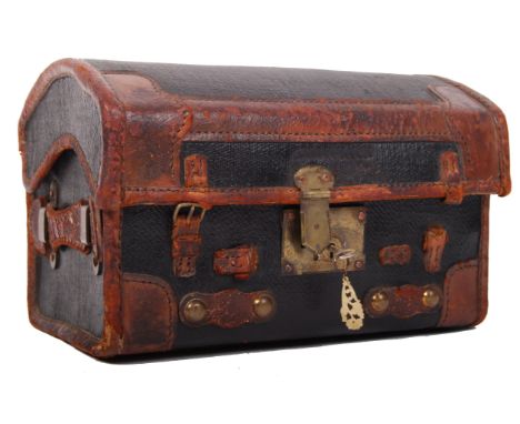 An early 20th century antique vintage domed ebonised canvas and leather bound travelling trunk / suitcase of small proportion