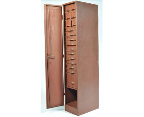 A 20th century vintage industrial upright metal locker containing an array of 18 drawers each with index card holders and ' D