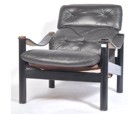 A 20th century retro vintage Danish Nordic safari lounge chair / armchair. The armchair dark brown button backed top grain to