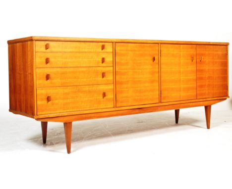 Alfred Cox - Heals - A rare 1960's retro vintage sycamore wood sideboard credenza comprising of having a bank of four graduat